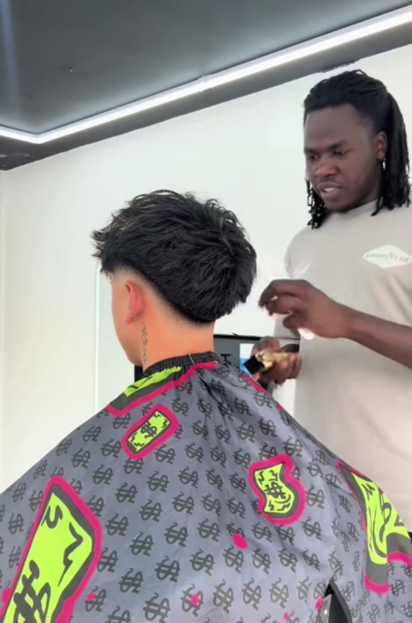 Barber shaping a customer’s hair